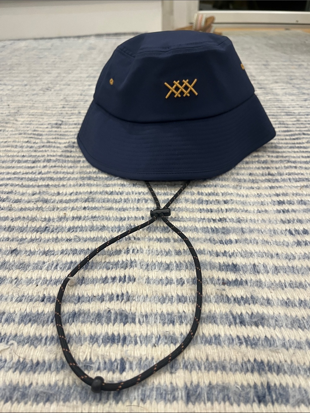 RHONE Navy Blue Bucket Hat with Gold Embroidered Logo